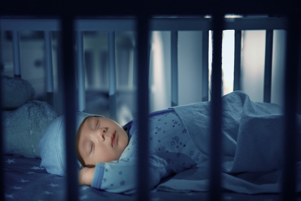 Baby sleeping in crib at night