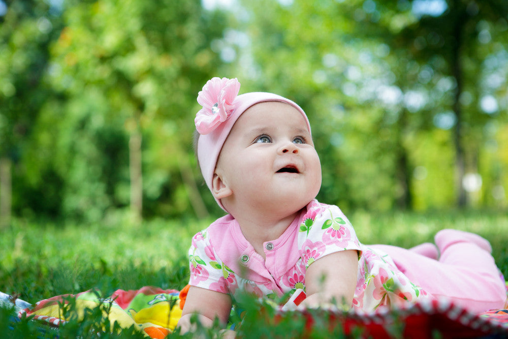Baby girl playing outside on the grass